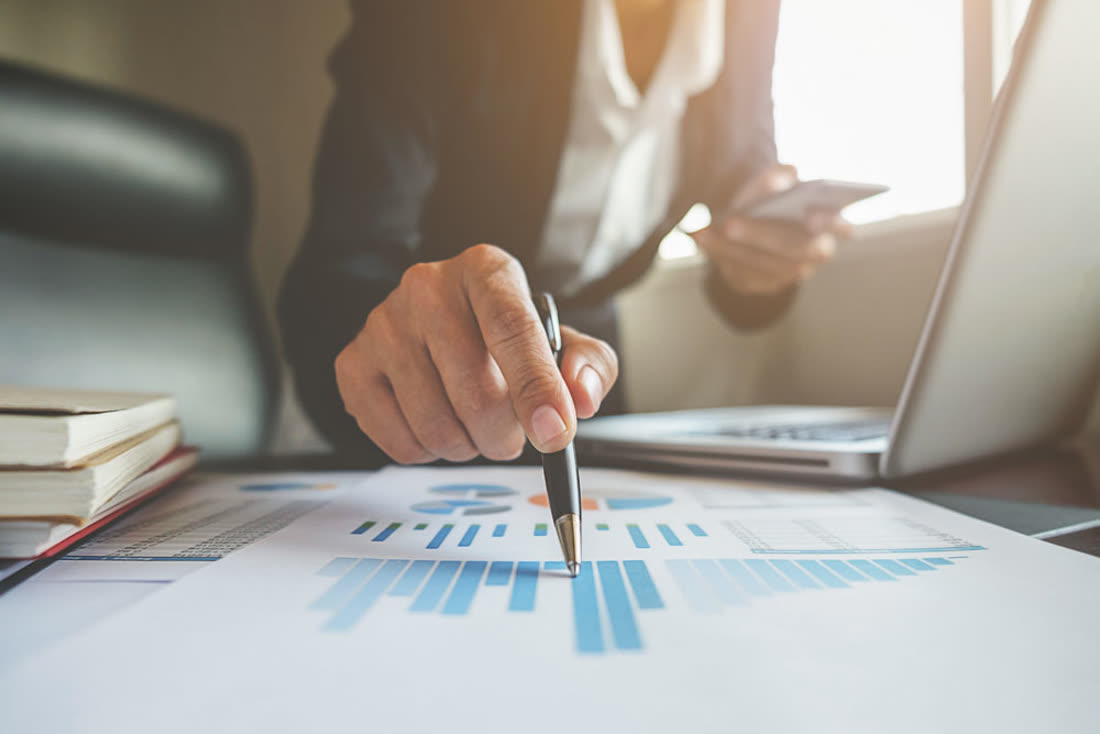 An Apex advisor reviewing a client's financial breakdown on a laptop