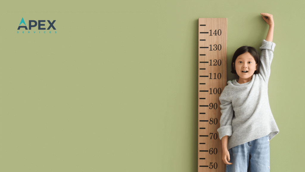 Child measuring height on a growth chart, representing accounting firm growth through outsourcing